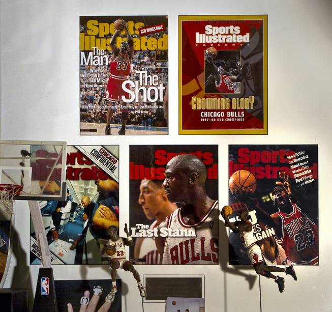 Cesar Flores was pleased to have this framed Michael Jordan collection of Sports Illustrated covers, Flores originally from Chicago and a big Bulls fan on Friday, August 8, 2014.