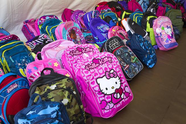Backpacks are lined up to be given away during a special back-to-school event for foster children at Square Salon, 1225 South Fort Apache Blvd., during a Sunday, August 10, 2014. The event was sponsored by the CASA Foundation, a local non-profit organization, in partnership with Square Salon and other organizations.