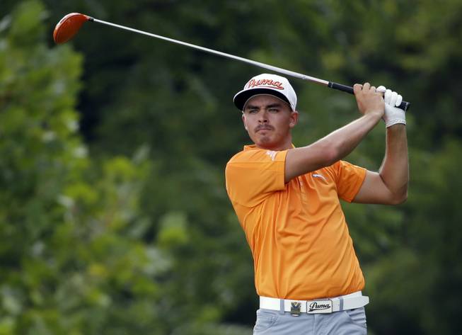 Rickie Fowler watches his tee shot on the fourth hole during the final round of the PGA Championship golf tournament at Valhalla Golf Club on Sunday, Aug. 10, 2014, in Louisville, Ky.