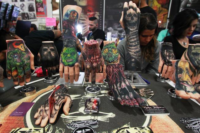 Rubber hands and feet, used for practice and display, are seen at the Pound of Flesh booth at the 3rd annual Art-N-Ink Tattoo Festival Saturday, Aug. 9, 2014 at the South Point.