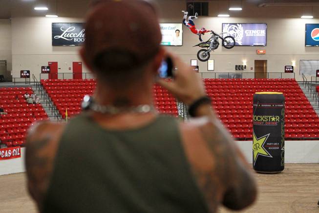 A rider sails through the arena during Metal Mulisha freestyle motocross demonstration at the 3rd annual Art-N-Ink Tattoo Festival Saturday, Aug. 9, 2014 at the South Point.