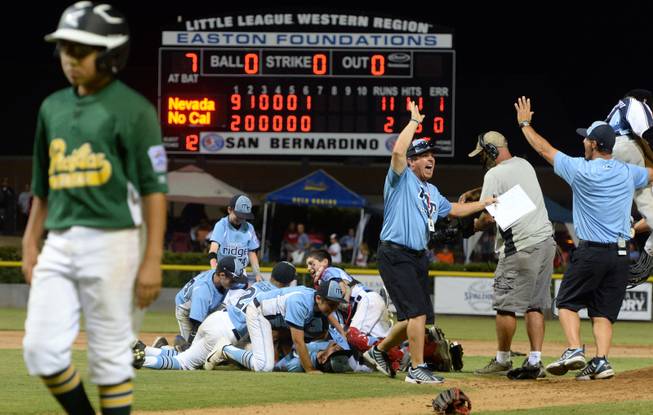 Nevada players and coaches celebrate after defeating Pacifica 11-2 Saturday night to win the Little League Western Regional Championship.  Mountain Ridge Little League, from Las Vegas, Nevada, defeated Pacifica Little League 11-2 Saturday August 9, 2014 in the Little League Western Regional Championship game at Al Houghton Stadium in San Bernardino. Nevada will play at the Little League World Series in Williamsport, PA. starting next week.  (Will Lester/Staff Photographer)