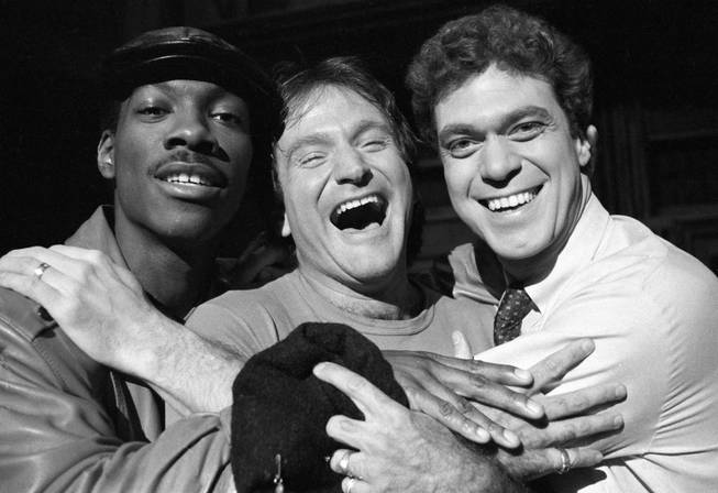 Robin Williams, center, takes time out from rehearsal at NBC's "Saturday Night Live" with cast members Eddie Murphy, left, and Joe Piscopo on Feb. 10, 1984.