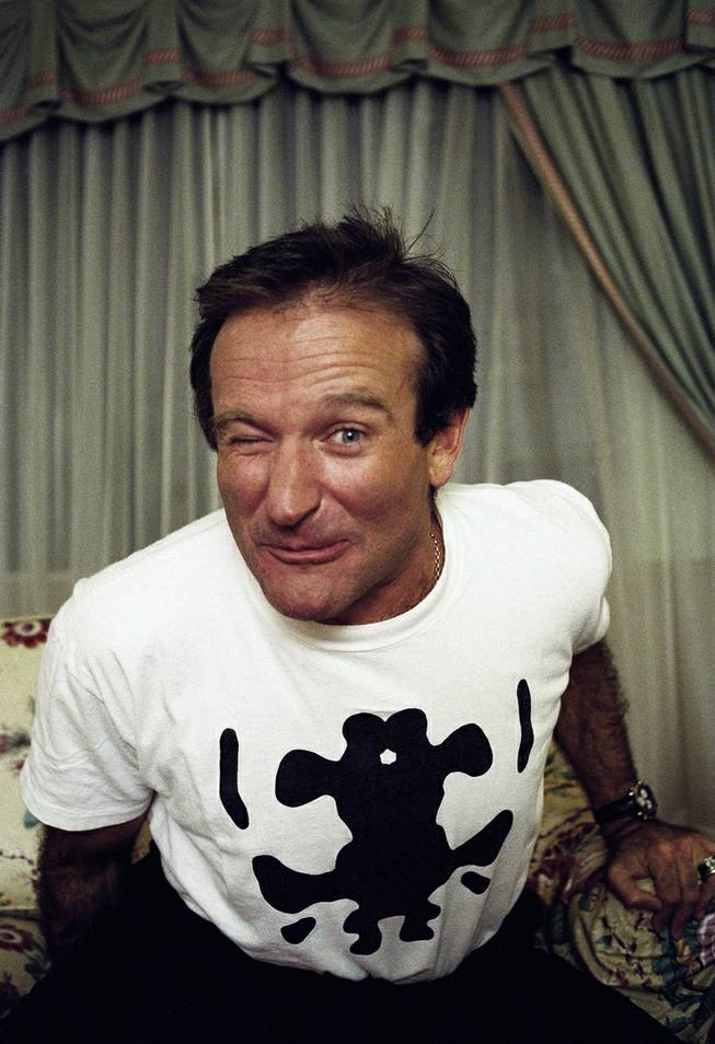 Comedian Robin Williams makes a face as he rises out of his chair during an interview, Nov. 15, 1993, in New York. 