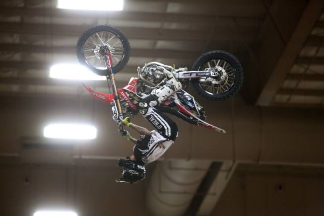 A rider performs a trick in the arena during Metal Mulisha freestyle motocross demonstration at the 3rd annual Art-N-Ink Tattoo Festival Friday, Aug. 8, 2014 at the South Point.
