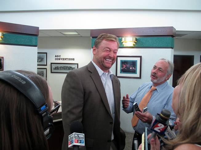 Sen. Dean Heller laughs with reporters Monday, Aug. 11, 2014, after meeting with a transportation roundtable sponsored by the Association of General Contractors at Granite Construction in Sparks. Among other things, he discussed efforts to lure Tesla Motors' $5 billion lithium batter plant to Nevada. 