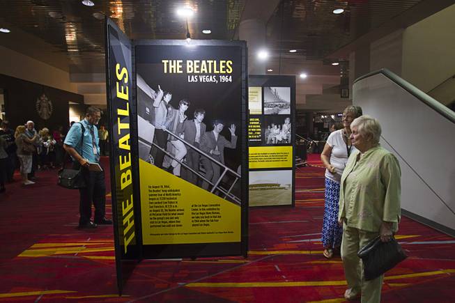 JoAnna Jones, left, and Dorothea Tannenbaum look over a multi-media exhibition during a news conference in the lobby of the Las Vegas Convention Center Tuesday, Aug. 12, 2014. The event celebrated the 50th anniversary of the Beatles concert in Las Vegas on August 20, 1964. The exhibition commemorating the event will be on display in the lobby of the LVCC through Oct. 27.