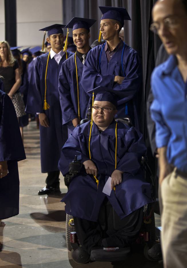 Lifelong friends Colton Shrum, Darius Martin and D'Aron Martin line up with other students at the Cashman Center  for their Odyssey Charter School graduation on Tuesday, June, 3, 2014.  L.E. Baskow
