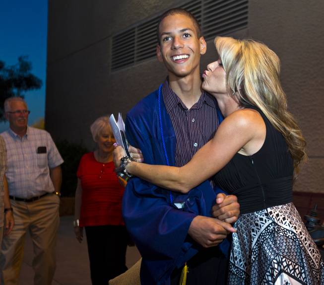Darius Martin is kissed by Shelly Shrum as they joke around following the Odyssey Charter School graduation at the Cashman Center on Tuesday, June, 3, 2014.  L.E. Baskow