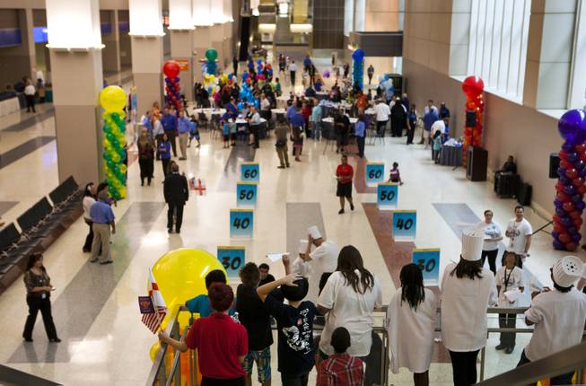 Children from the Boys & Girls Clubs of Southern Nevada take turns in practice throws before the start of the Paper Plane Palooza competition at McCarran International Airport on Tuesday, August 12, 2014.
