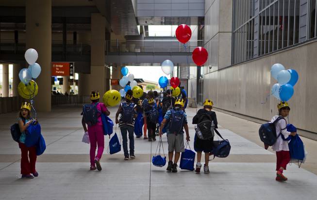 Children from the Boys & Girls Clubs of Southern Nevada leave from McCarran International Airport  with all their new things after the Paper Plane Palooza competition on Tuesday, August 12, 2014.