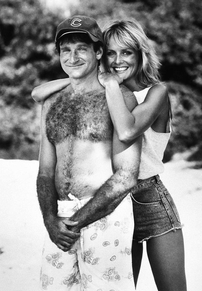 Actor Robin Williams, left, in character as ex-Chicago fireman Jack Moniker poses with actress and model Twiggy, also in character for the comedy Club Paradise, 1986.