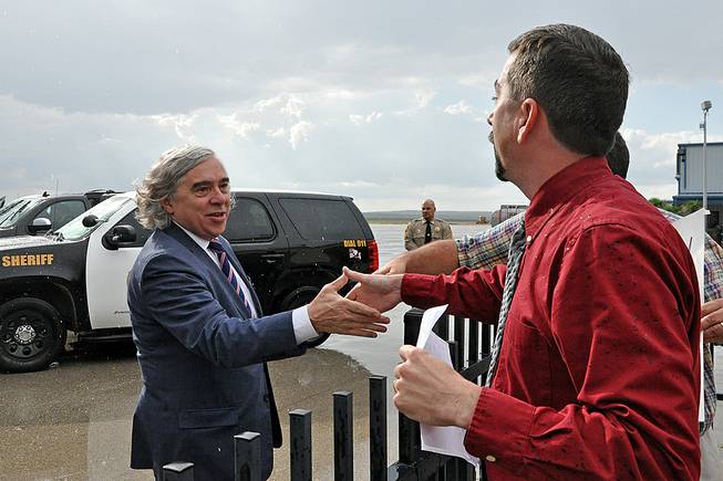 Energy Secretary Ernest Moniz is welcomed at the Carlsbad, N.M., airport as he arrives in southeastern New Mexico Monday, Aug. 11, 2014, to visit the government's troubled nuclear waste dump and talk with residents about the mysterious radiation leak and truck fire that have shuttered the Waste Isolation Pilot Plant indefinitely. About a dozen community leaders and residents were at the Carlsbad airport to welcome Moniz and show their continued support for the plant, which is the federal government's only permanent repository for waste from decades of nuclear bomb building and employs about 650 people. 
