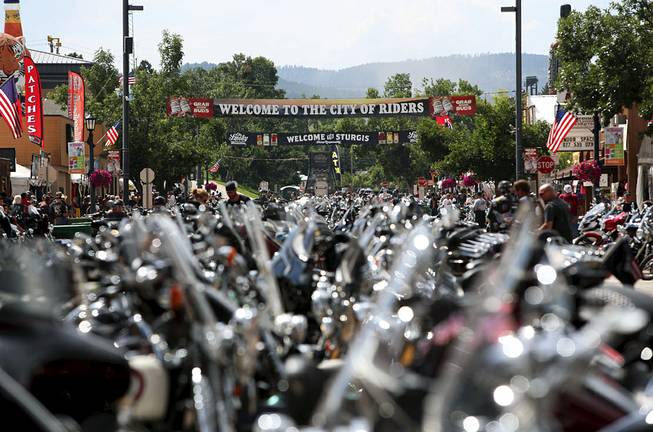 This Aug. 1, 2014, photo shows the streets of Sturgis, S.D., lined with motorcycles days before the official kickoff of the 74th annual Sturgis Motorcycle Rally. Members of a Black Hills family and their friends say they mean no harm with a betting pool they run on how many bikers will die during the annual rally. This year, 12 people put in $5 each, with the winner pocketing $60. 