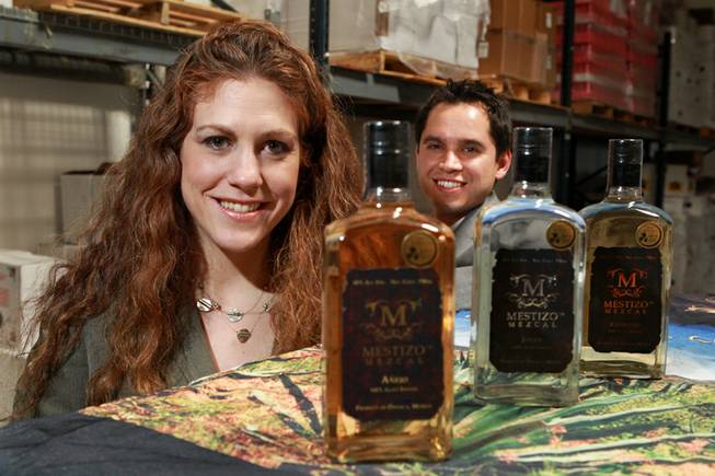 Jessica Rosman and Arturo Palencia of Skere Spirits are seen with the three different mezcals their company produces Friday, Aug. 8, 2014.