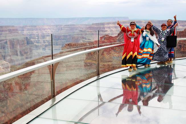 Hualapai tribe members pose for a photo on the Skywalk after the official opening of the newly paved section of Diamond Bar Road leading to Grand Canyon West Tuesday, Tuesday, Aug. 12, 2014.