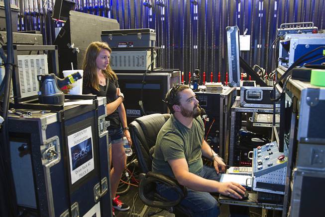 Head carpenter Matt Cowles prepares for the company's 299th performance during a backstage tour of "Ghost The Musical" at the Smith Center for the Performing Arts Wednesday Aug. 13, 2014. Elizabeth Aresti looks on at left. The musical runs through Sunday, Aug. 17.