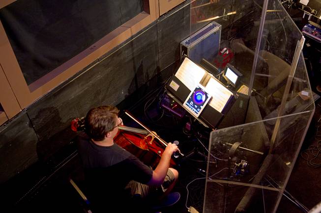 A musician warms up in the orchestra pit during a backstage tour of "Ghost The Musical" at the Smith Center for the Performing Arts Wednesday Aug. 13, 2014. The musical runs through Sunday, Aug. 17.