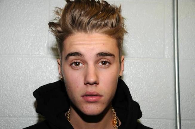 This Jan. 23, 2014, photo made available by the Miami Beach Police Department shows Justin Bieber at the police station in Miami Beach, Fla.