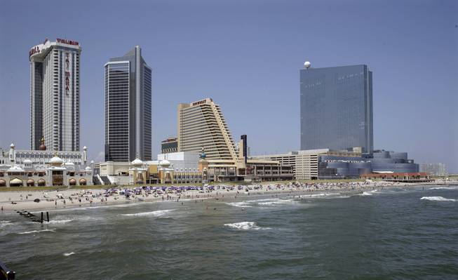 This Wednesday, July 23, 2014, photo shows casinos along the Atlantic City, N.J. boardwalk, from left, the Trump Taj Mahal Casino, with its Chairman Tower, the Showboat Casino Hotel and the Revel Casino Hotel.
