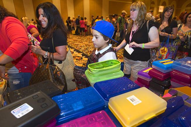 Kevin Hanly, 10, helps his mother Helen Hanly, left, pick up free school supplies during MGM Resorts annual Educator Appreciation Day at the Mirage Thursday Aug. 14, 2014. Helen Hanly is an kindergarten teacher at Batterman Elementary School. In addition to school supplies provided by MGM Resort employees, a variety of agencies participated in the days activities to introduce educators to teaching resources available in the community.