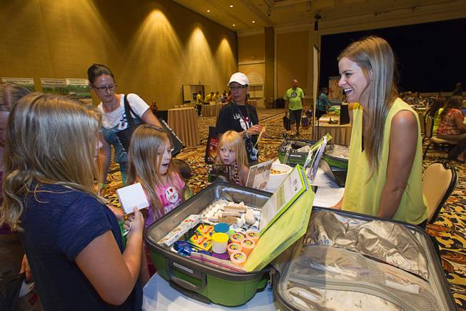 Mckenzie Peterson, right, of Desert Research Institute's GreenPower, talks with children of teachers during MGM Resorts annual Educator Appreciation Day at the Mirage Thursday Aug. 14, 2014.