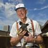 Bob Combs of R.C. Farms Inc. holds one of his many piglets on Wednesday, Aug. 13, 2014.