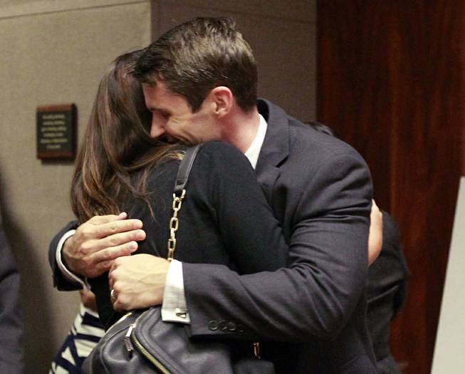 State Department Special Agent Christopher Deedy hugs his wife, Stephanie Deedy, following his acquittal on murder charges Thursday, Aug. 14, 2014, in the November 2011 shooting of a man at a Hawaii fast food restaurant. Jurors couldn't reach a verdict on other, lesser chargers. 