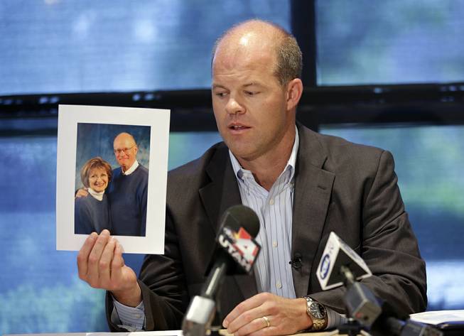 Attorney Paxton Guymon holds a photograph of Jim and Jan Harding during a news conference in Salt Lake City on Thursday, Aug. 14, 2014. Jan Harding, 67, is in critical condition at a Salt Lake City hospital's burn unit, unable to talk and fighting for her life, Guymon said. 