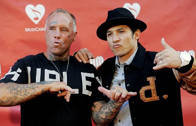 Skateboarding legends Jay Adams, left, and Christian Hosoi pose together at the Ninth Annual MusicCares MAP Fund Benefit Concert at Club Nokia on Thursday, May 30, 2013, in Los Angeles. Adams reportedly died of a heart attack Thursday, Aug. 15, 2014, on vacation in Mexico.