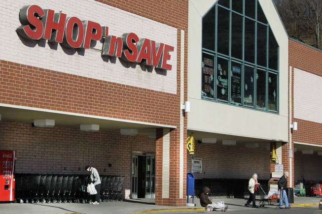 In this Jan. 9, 2012, file photo, customers exit a Shop' Save grocery store in Mount Lebanon, Pa. Supervalu said Friday, Aug. 15, 2014, that a potential data breach may have impacted about 200 of its stores and reached stores it sold off last year.