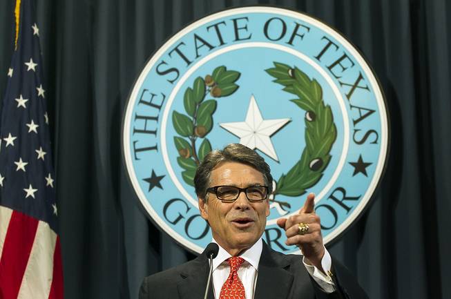 Texas Gov. Rick Perry speaks during a news conference on Saturday, Aug. 16, 2014, in Austin, Texas. Perry said Saturday that the indictment against him was an "outrageous" abuse of power and vowed to fight it.