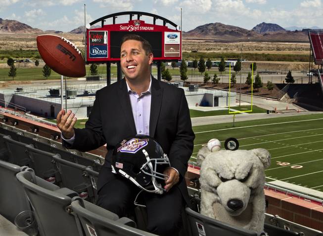 John Saccenti, the new executive director of the Royal Purple Las Vegas Bowl, kicks back at Sam Boyd Stadium on Thursday, Aug. 14, 2014. He's been working in sports in Las Vegas for the past 16 years, starting out as the mascot for the Las Vegas Thunder hockey team and working his way up. 