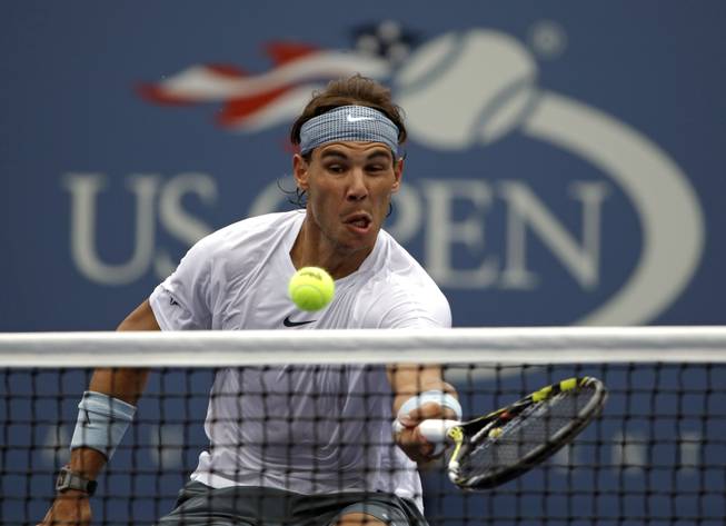 In this Aug. 26, 2013, photo, Rafael Nadal returns a shot to Ryan Harrison during the first round of the 2013 U.S. Open tennis tournament in New York.
