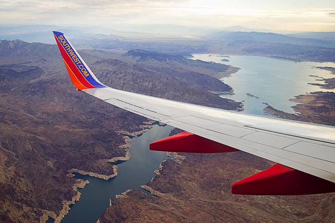 The white "bathtub" ring at Lake Mead is viewed from a Southwest Airlines passenger jet Monday, Aug. 18, 2014. The bathtub ring of light minerals shows the high-water mark of 1983.