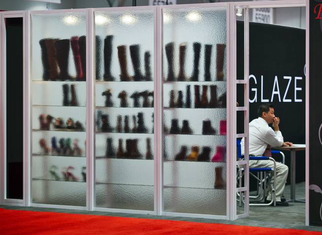 Boots and shoes with Glaze are on display and seen through glass during the MAGIC Marketplace Fall Show at the Las Vegas Convention Center on Tuesday, August 19, 2014.  L.E. Baskow
