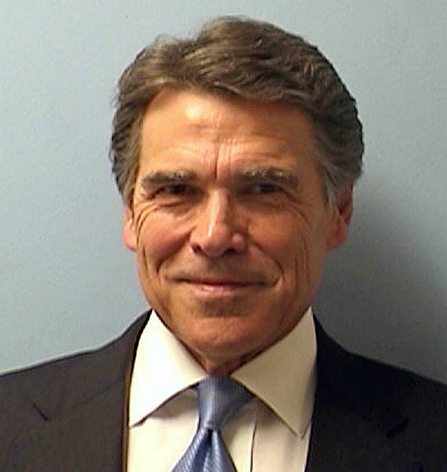 This image provided by the Austin Police Department shows Texas Gov. Rick Perry while being booked at the Blackwell-Thurman Criminal Justice Center in Austin, Texas, for two felony indictments of abuse of power on Tuesday, Aug. 19, 2014, in Austin, Texas.