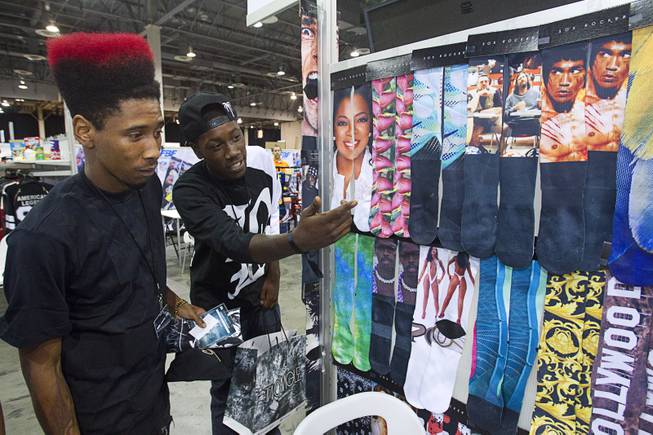 Turf dancer Alonzo "Turf" Jones, left, and Reggie Williams look over socks at the Sox Rocker booth during the Modern Assembly fashion trade show at the Sands Expo & Convention Center Wednesday, Aug. 20, 2014. The show is a collection of six shows: The Accessories Show, Agenda, Capsule, Liberty, Mrket, and Stitch.