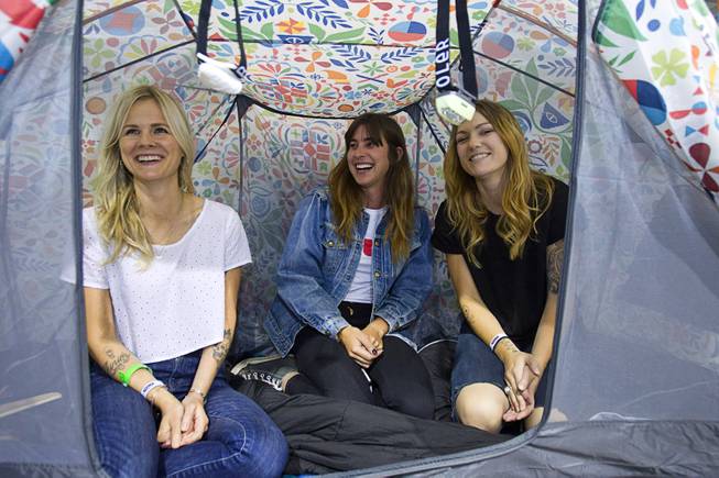 Kara Murff, left, Julia Heit, center, and Tori George pose in a "Rainbro" pattern tent during the Modern Assembly fashion trade show at the Sands Expo & Convention Center Wednesday, Aug. 20, 2014. The Rainbro line of tents and Napsack sleeping bag are available online and will be in stores this fall, George said. The show is a collection of six shows: The Accessories Show, Agenda, Capsule, Liberty, Mrket, and Stitch.