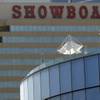 In this Wednesday, July 23, 2014, photo, people relax on a high deck at Revel resort near neighboring Showboat in Atlantic City. The state Gaming Enforcement Division gave final approval to Revel's shutdown on Sept. 1 and 2, signing the order Tuesday night and releasing it Wednesday, Aug. 20, 2014.