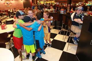 Mountain Ridge Little League teammates cheer at the Red Rock Resort after their older teammates won to advance to the finals of the Little League World Series Wednesday, Aug. 20, 2014.