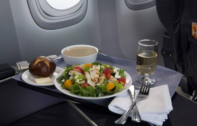This product image provided by United Airlines shows a Strawberry Fields Salad, one of a variety of the airline's new first class food options. The Chicago-based airline on Thursday, Aug. 21, 2014, announced that it’s upgrading first-class food options and replacing snacks with full meals on some of its shortest flights.
