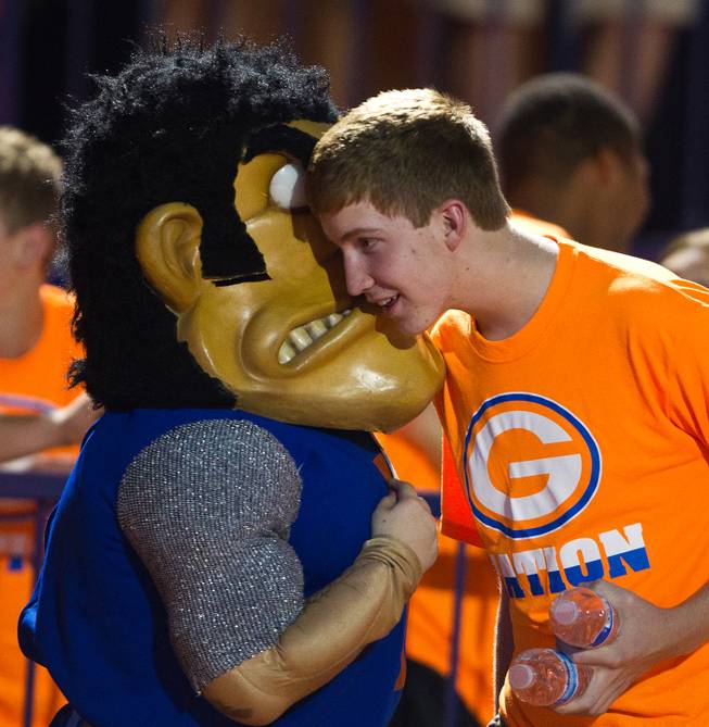The Bishop Gorman mascot whispers a message to a fan on the sidelines during the game versus Brophy Prep which ended 44-0 on Friday, August 22, 2014.