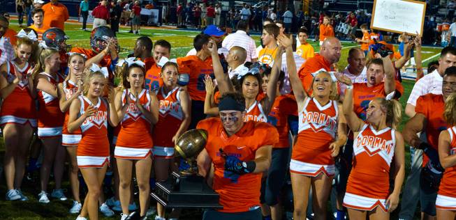 Bishop Gorman players, coaches and cheerleaders celebrate their Sollengber Classic win versus Brophy Prep with a score of 44-0 on Friday, August 22, 2014.