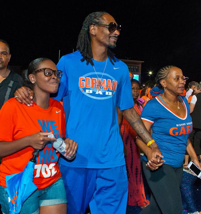 Snoop Dogg leaves the field with his family members after Bishop Gorman handily beat Brophy Prep 44-0 on Friday, August 22, 2014.