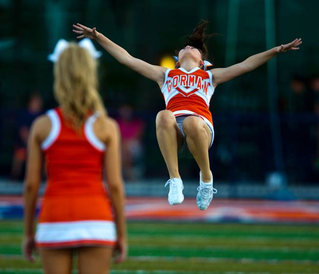 A Bishop Gorman cheerleader flips for the crowd before the start of the game against Brophy Prep on Friday, August 22, 2014.