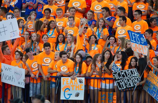 Bishop Gorman fans have signs at the ready as they prepare to battle against Brophy Prep on Friday, August 22, 2014.