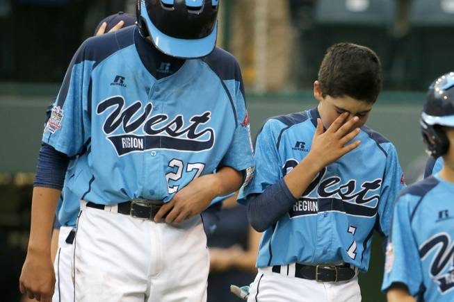 Las Vegas' Brennan Holligan (27), and Josiah Cromwick (7) walk off the field after a 7-6 loss in the United States Championship game to Chicago at the Little League World Series tournament in South Williamsport, Pa., Saturday, Aug. 23, 2014. (AP Photo/Gene J. Puskar