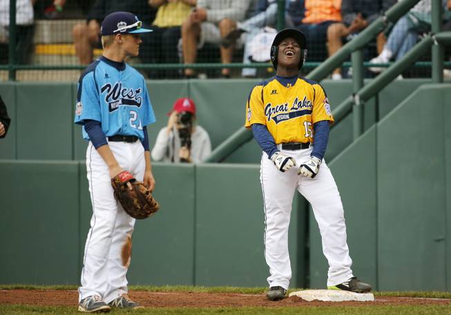 Chicago's Darion Radcliff (15) celebrates after driving in a run with a single off Las Vegas' Brennan Holligan as Las Vegas first baseman Austin Kryszczuk (21) watches in the first inning of a U.S. championship game at the Little League World Series on Saturday, Aug. 23, 2014, in South Williamsport, Pa.