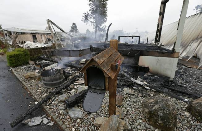 A mailbox is all that remains of one of four mobile homes which were destroyed in a gas fire Sunday, Aug. 24, 2014, at the Napa Valley Mobile Home Park, in Napa, Calif. A large earthquake caused significant damage and left at least three critically injured in California's northern Bay Area early Sunday, igniting fires, sending at least 87 people to a hospital, knocking out power to tens of thousands and sending residents running out of their homes in the darkness.